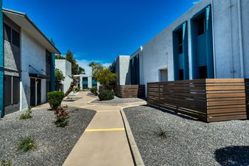 A modern building complex with a gravel pathway at Connect on Missouri, Phoenix, 85015